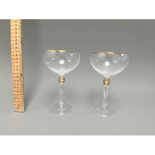 4 - A Pair of Crystal Clear Sara Gold Stem Wine Glasses. A pair of clear crystal wine glasses, likely Sa... 