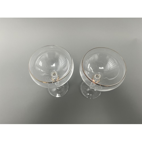 4 - A Pair of Crystal Clear Sara Gold Stem Wine Glasses. A pair of clear crystal wine glasses, likely Sa... 