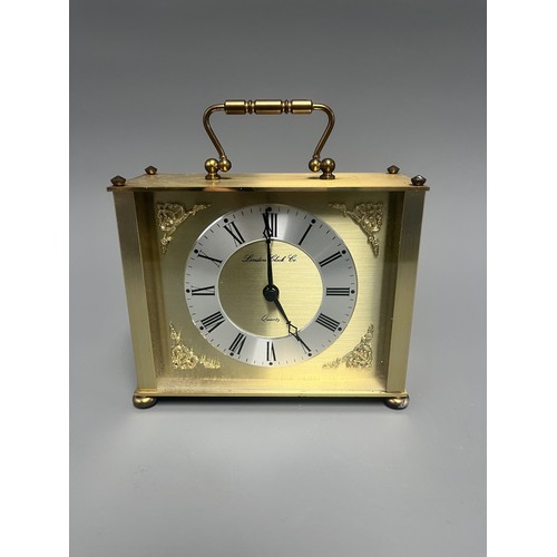 12 - London Clock Co. Gold Toned Quartz Carriage Clock. A single gold-toned brass carriage clock by Londo... 