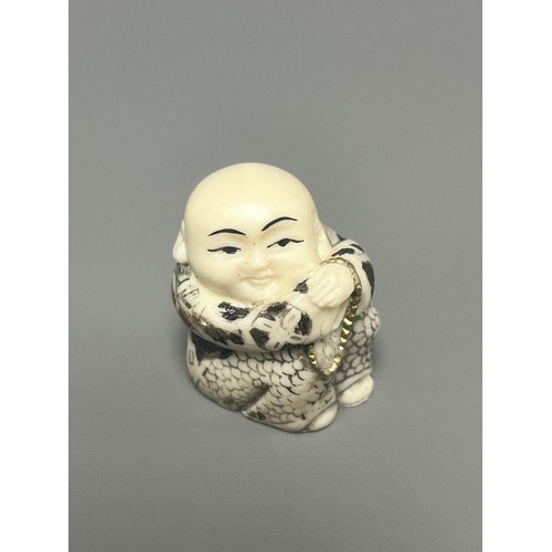 15 - Collection of East Asian Figurines including Porcelain Buddha etc. East Asian figurines including a ... 