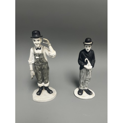 31 - A Pair of Mid-20th Century Ceramic Laurel and Charlie Chaplin Figurines. A pair of molded ceramic fi... 