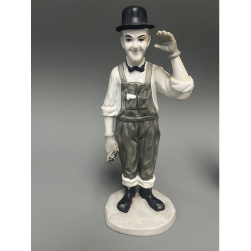 31 - A Pair of Mid-20th Century Ceramic Laurel and Charlie Chaplin Figurines. A pair of molded ceramic fi... 