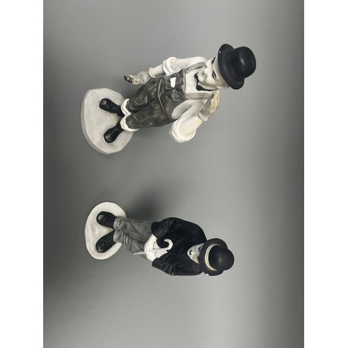 31 - A Pair of Mid-20th Century Ceramic Laurel and Charlie Chaplin Figurines. A pair of molded ceramic fi... 