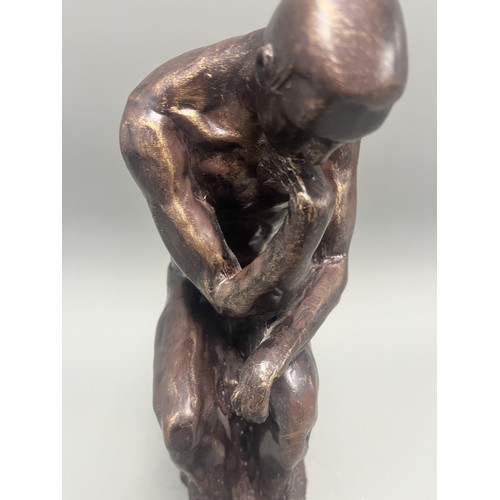 37 - A bronze style resin figure of 'The Thinking Man' by Auguste Rodin. 32 cms tall. Detailed and in goo... 