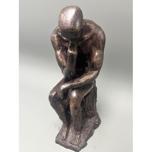 37 - A bronze style resin figure of 'The Thinking Man' by Auguste Rodin. 32 cms tall. Detailed and in goo... 