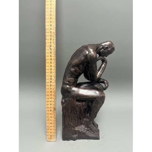 37 - A bronze style resin figure of 'The Thinking Man' by Auguste Rodin. 32 cms tall. Detailed and in goo... 