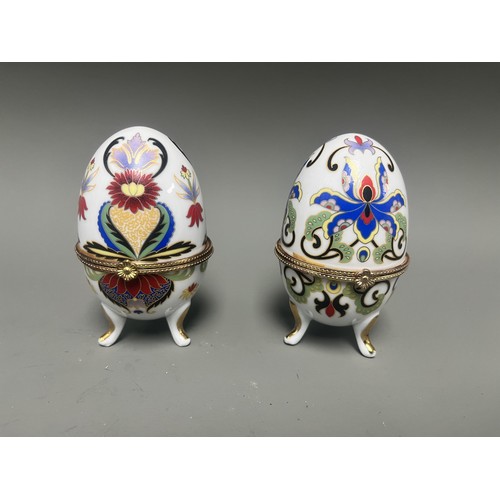 41 - A pair of decorative hinged trinket boxes crafted from white porcelain, designed in an ornamental eg... 