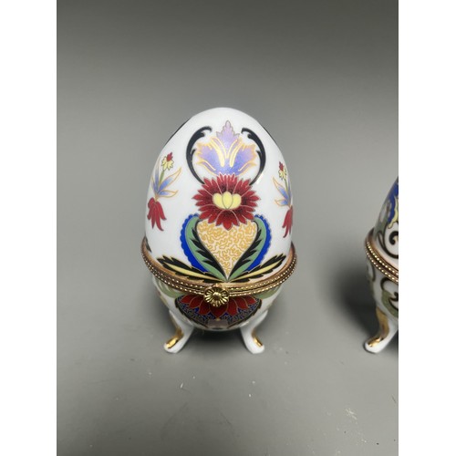 41 - A pair of decorative hinged trinket boxes crafted from white porcelain, designed in an ornamental eg... 