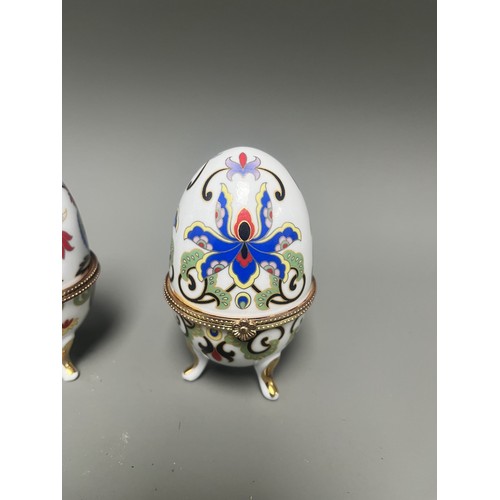41 - A pair of decorative hinged trinket boxes crafted from white porcelain, designed in an ornamental eg... 