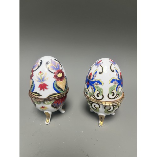 41 - A pair of decorative hinged trinket boxes crafted from white porcelain, designed in an ornamental eg... 