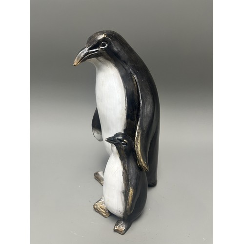 43 - Carved and Painted Wood Sculpture of Two Penguins. A single decorative sculpture, carved from wood, ... 