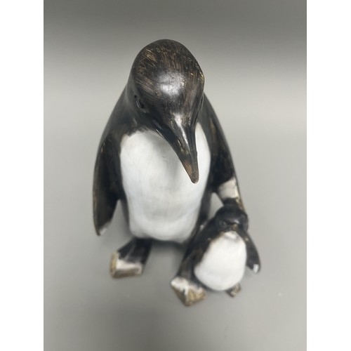 43 - Carved and Painted Wood Sculpture of Two Penguins. A single decorative sculpture, carved from wood, ... 