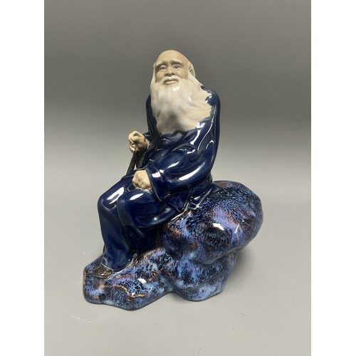45 - Ceramic Figurine of a Scholar or Immortal with Cobalt and Flambe Glaze. A single ceramic figurine de... 
