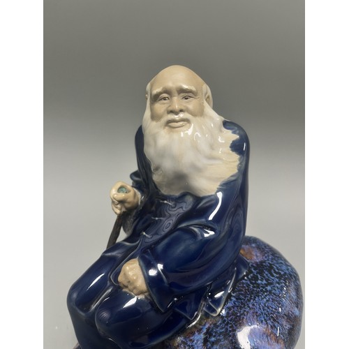 45 - Ceramic Figurine of a Scholar or Immortal with Cobalt and Flambe Glaze. A single ceramic figurine de... 