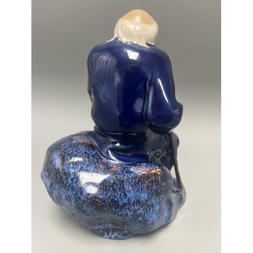 45 - Ceramic Figurine of a Scholar or Immortal with Cobalt and Flambe Glaze. A single ceramic figurine de... 