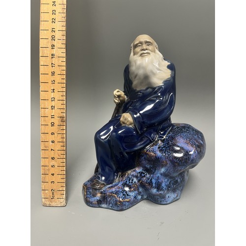 45 - Ceramic Figurine of a Scholar or Immortal with Cobalt and Flambe Glaze. A single ceramic figurine de... 