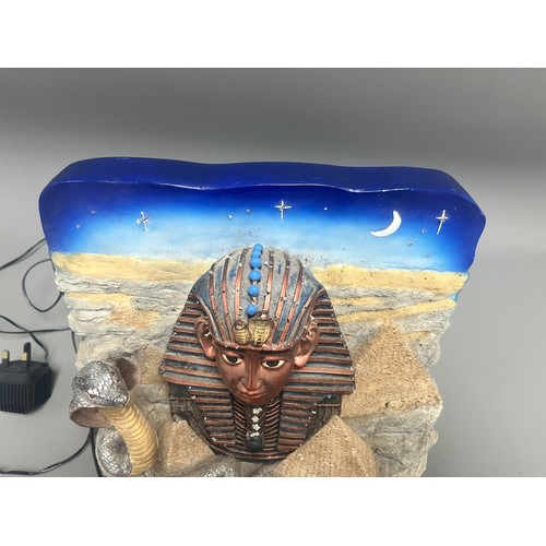 50 - An Egyptian Revival Illuminated Wall Plaque Depicting Tutankhamun's Mask. A single modern illuminate... 