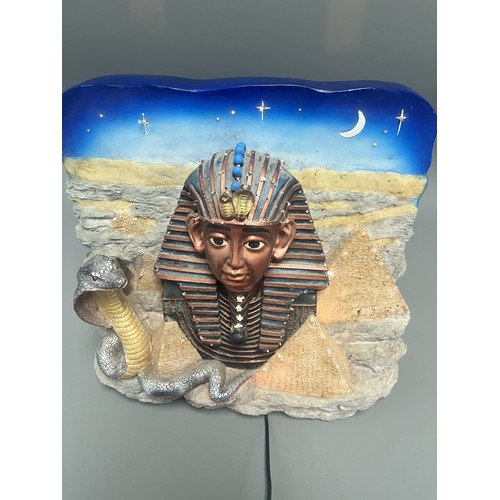 50 - An Egyptian Revival Illuminated Wall Plaque Depicting Tutankhamun's Mask. A single modern illuminate... 