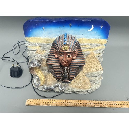 50 - An Egyptian Revival Illuminated Wall Plaque Depicting Tutankhamun's Mask. A single modern illuminate... 