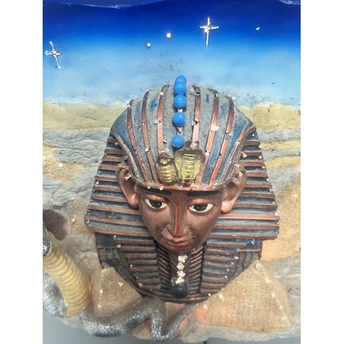 50 - An Egyptian Revival Illuminated Wall Plaque Depicting Tutankhamun's Mask. A single modern illuminate... 