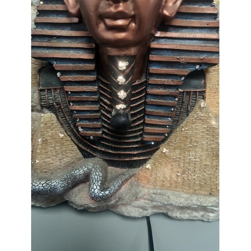 50 - An Egyptian Revival Illuminated Wall Plaque Depicting Tutankhamun's Mask. A single modern illuminate... 
