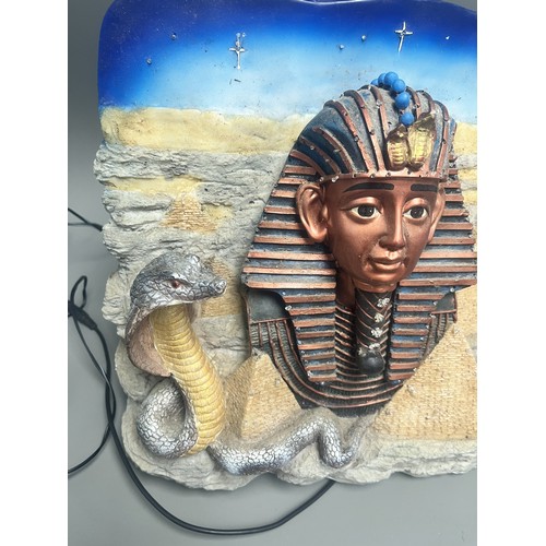 50 - An Egyptian Revival Illuminated Wall Plaque Depicting Tutankhamun's Mask. A single modern illuminate... 