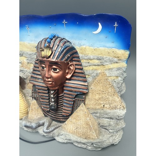 50 - An Egyptian Revival Illuminated Wall Plaque Depicting Tutankhamun's Mask. A single modern illuminate... 