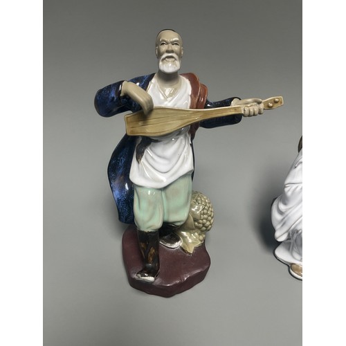 51 - A Pair of Chinese Shiwan Mudman Pottery Figurines, Musician and Scholar. A pair of Chinese Shiwan Mu... 