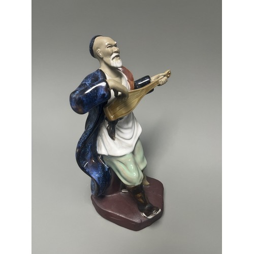 51 - A Pair of Chinese Shiwan Mudman Pottery Figurines, Musician and Scholar. A pair of Chinese Shiwan Mu... 