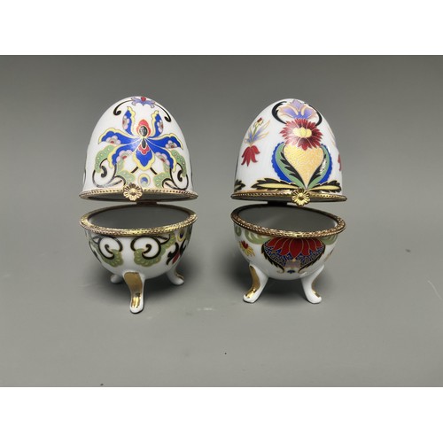 41 - A pair of decorative hinged trinket boxes crafted from white porcelain, designed in an ornamental eg... 