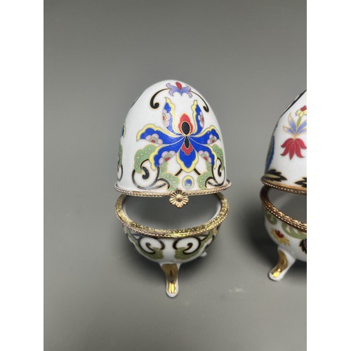 41 - A pair of decorative hinged trinket boxes crafted from white porcelain, designed in an ornamental eg... 