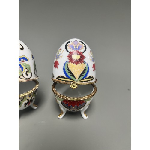 41 - A pair of decorative hinged trinket boxes crafted from white porcelain, designed in an ornamental eg... 