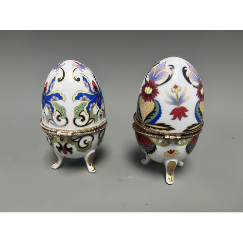 41 - A pair of decorative hinged trinket boxes crafted from white porcelain, designed in an ornamental eg... 