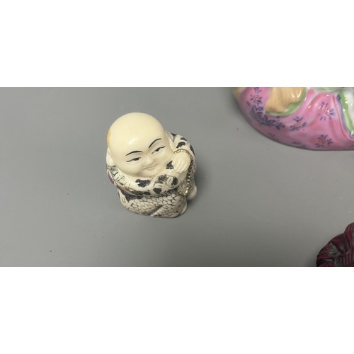 15 - Collection of East Asian Figurines including Porcelain Buddha etc. East Asian figurines including a ... 