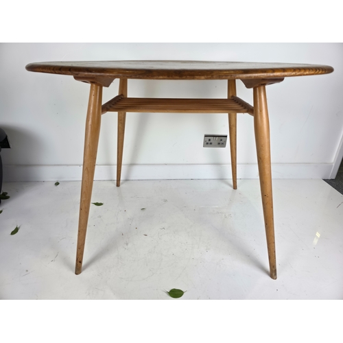 42 - Ercol Oval Breakfast Table With Magazine Shelf