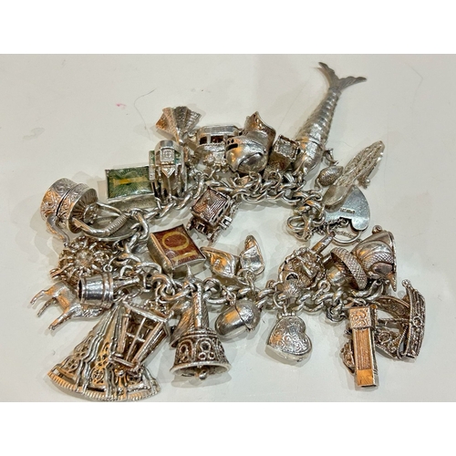 103 - Heavy Silver Charm Bracelet with some Fabulous Articulated and Hinged Charms