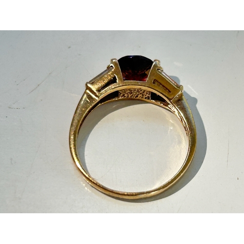 107 - 9ct Gold Garnet and Tapered Baguette Cut Diamond Ring - Fully hallmarked