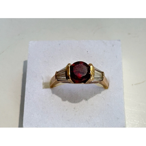 107 - 9ct Gold Garnet and Tapered Baguette Cut Diamond Ring - Fully hallmarked