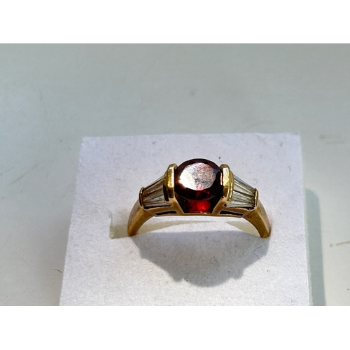 107 - 9ct Gold Garnet and Tapered Baguette Cut Diamond Ring - Fully hallmarked