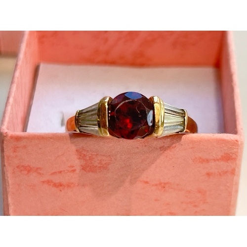 107 - 9ct Gold Garnet and Tapered Baguette Cut Diamond Ring - Fully hallmarked