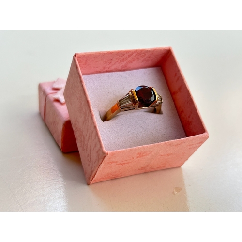 107 - 9ct Gold Garnet and Tapered Baguette Cut Diamond Ring - Fully hallmarked