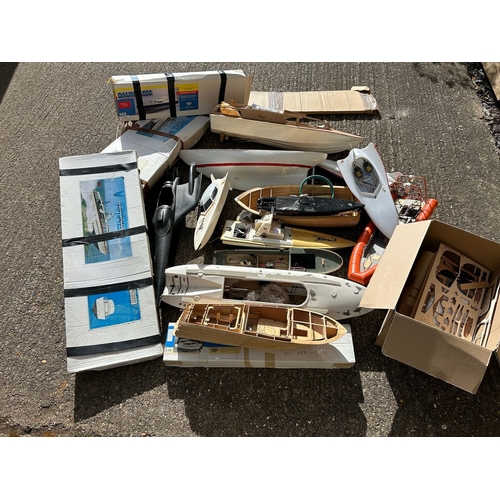 155 - Substantial quantity of remote control boats in various stages of build, wooden and plastic hulled s... 