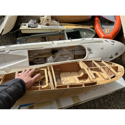 155 - Substantial quantity of remote control boats in various stages of build, wooden and plastic hulled s... 