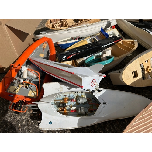 155 - Substantial quantity of remote control boats in various stages of build, wooden and plastic hulled s... 