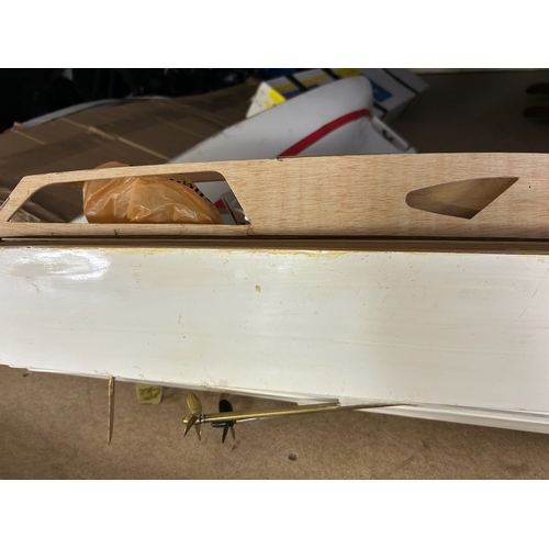 155 - Substantial quantity of remote control boats in various stages of build, wooden and plastic hulled s... 