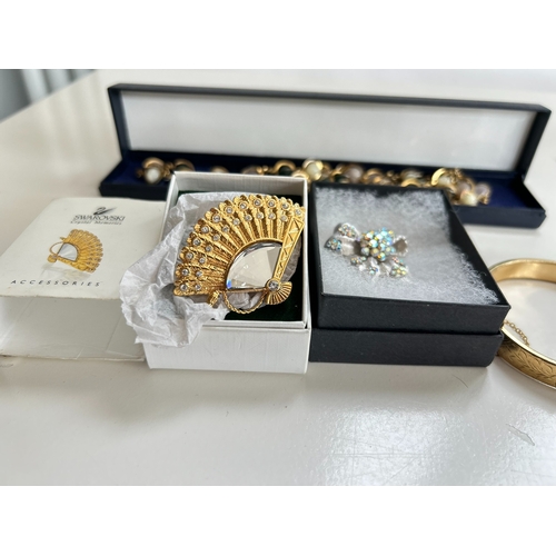 39 - Good collection of costume jewellery, including bangles, necklaces, brooch, bracelet, by Swarovski a... 