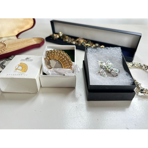 39 - Good collection of costume jewellery, including bangles, necklaces, brooch, bracelet, by Swarovski a... 