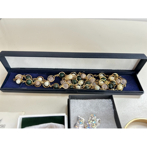 39 - Good collection of costume jewellery, including bangles, necklaces, brooch, bracelet, by Swarovski a... 