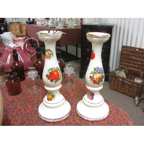 127 - Pair of hand painted candle sticks.