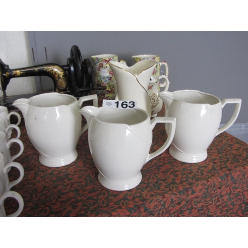 163 - 3 Large milk jugs and vase.